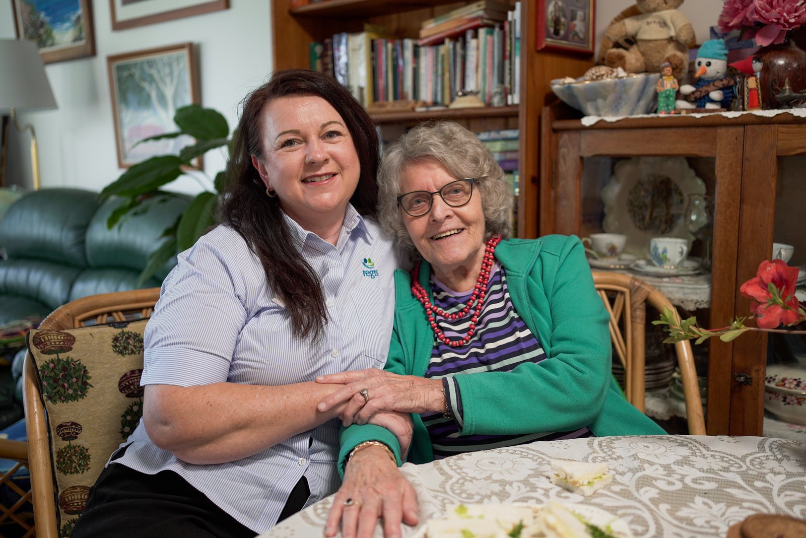 Regis carer sitting with a client in her home