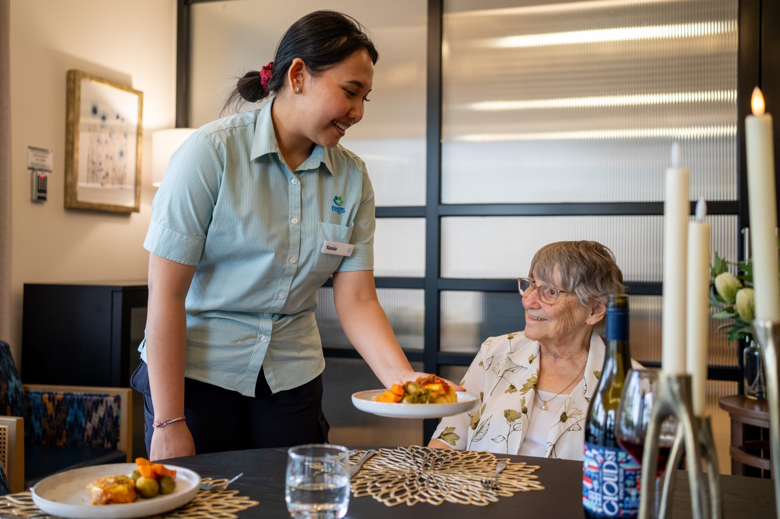 Regis staff serving meal to client at day therapy centre
