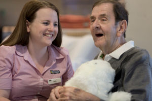 Regis Dandenong North - Resident and carer with PARO